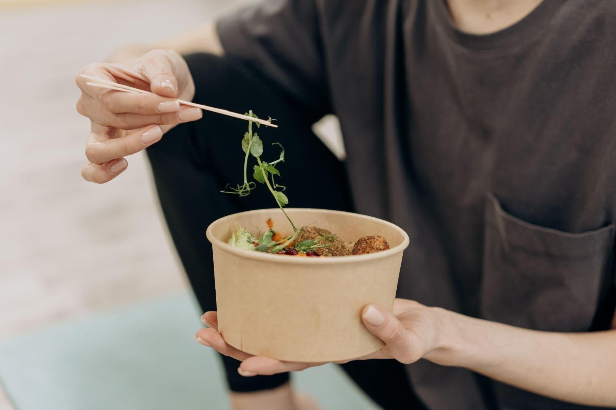 woman eating a healthy meal with herbs