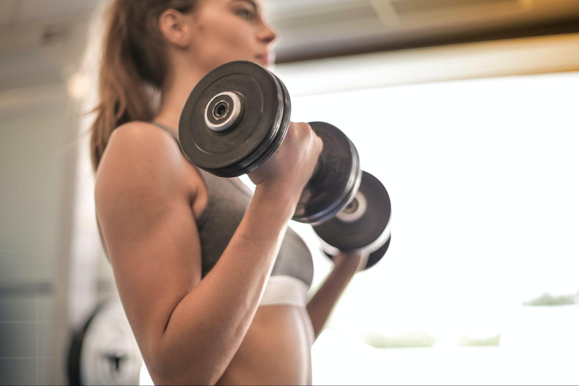 woman holding dumbbells